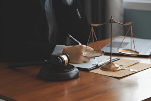 Lawyers reviewing contract with justice scale in office