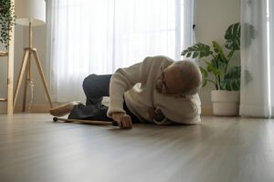 Asian senior man falls while using walker at home.