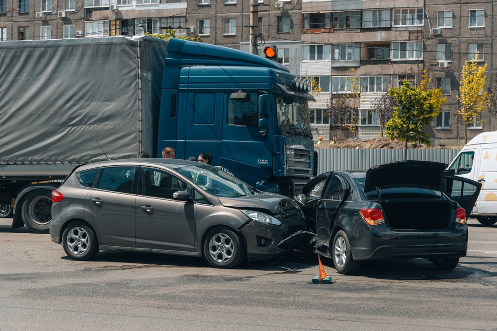 Two damaged cars after a collision with a large truck at a city intersection in South Carolina.