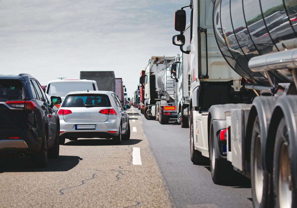 Cars and large semi-trucks driving closely together on a South Carolina highway.