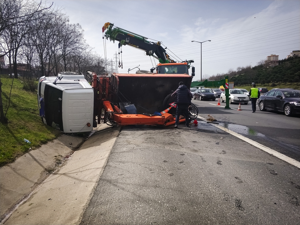 Emergency crews working at the scene of a truck rollover crash on a highway