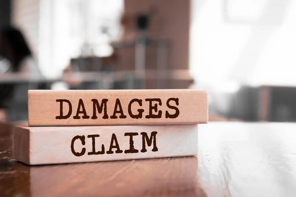 Damages & Claim Written on a Wood Blocks
