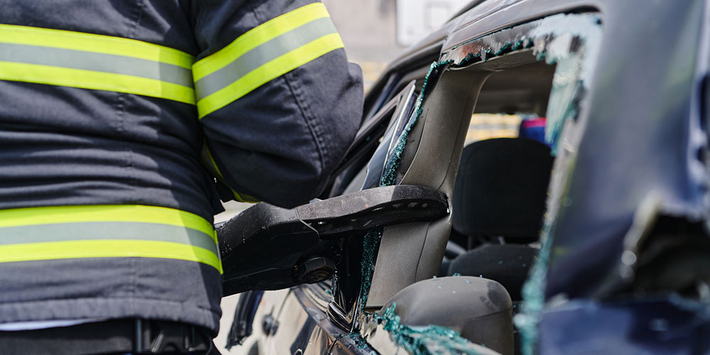 Firefighters working to rescue occupants from a damaged vehicle, illustrating the urgency of documenting crash conditions and preserving evidence immediately after a serious collision.