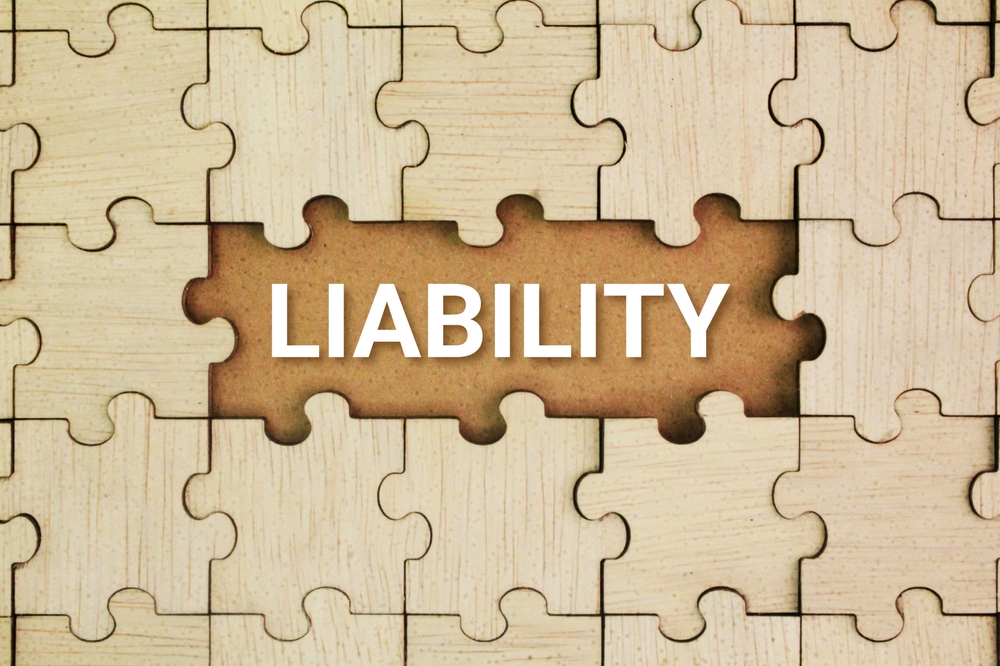 A puzzle with a missing center piece revealing the word ‘Liability.