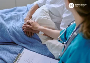 Nurse caring for an elderly patient with bed sores in a Charleston nursing home.